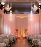Refined Ceremony Space
Photography: Michael Carr Photography
Read More:
http://www.insideweddings.com/weddings/exceptional-wedding-event-in-historical-houston-building/468/ Crystal chandeliers above indoor ceremony with drapery