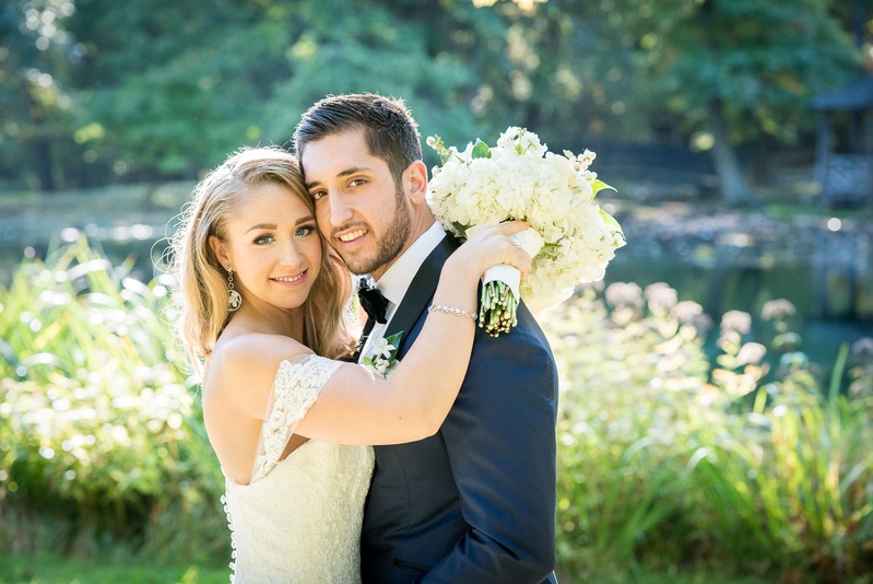 Bride Embracing Groom in Off-Shoulder Gown
Photography: Robert Evans for 5th Avenue Digital
Read More:
http://www.insideweddings.com/weddings/outdoor-jewish-wedding-ceremony-at-stunning-chateau-in-new-jersey/1058/ Bride holding wedding bouquet with hands on groom shoulders off shoulder strap anne barge gown