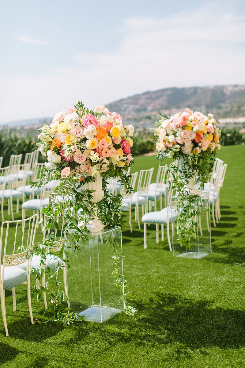 Light Blue Guest Seating at Ceremony
Photography: Ashley Paige Photography
Read More:
http://www.insideweddings.com/weddings/romantic-ocean-view-ceremony-charming-reception-in-california/1337/ wedding ceremony laguna niguel acrylic riser pink orange yellow flower arrangements light blue chair