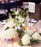 Low Centerpieces in Ginger Jars
Photography: Patricia Lyons Photography
Read More:
http://www.insideweddings.com/weddings/southern-outdoor-wedding-at-the-grooms-plantation-in-virginia/1003/ Wedding reception white texture linen tablecloth multiple arrangements of white flowers in jars