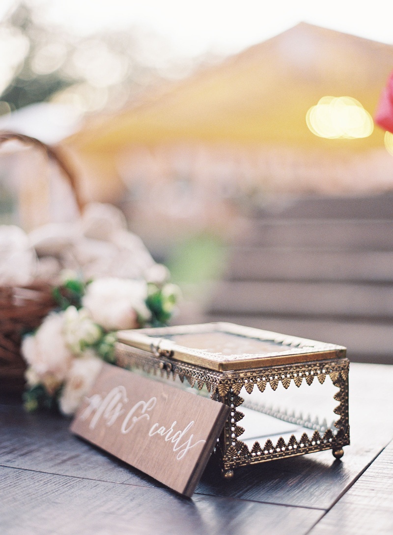 Antique-Looking Card Box
Photography: Eric Kelley
Read More:
http://www.insideweddings.com/weddings/chapel-ceremony-tented-reception-in-the-south-carolina-lowcountry/1057/ Wedding card and gift box clear jewelry box with wood sign next to flowers in basket