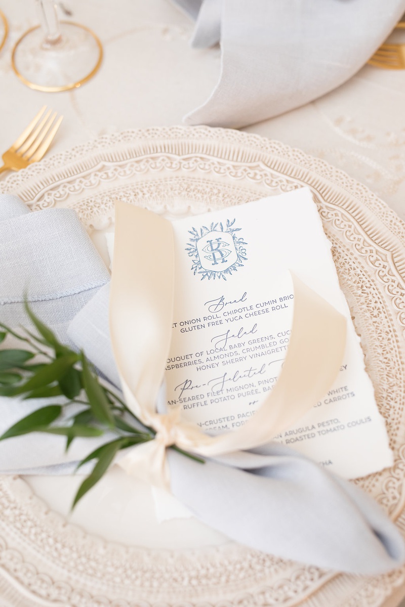 Elegant Blue %26 Grey Menu Card
Photography: Ashley Paige Photography
Read More:
http://www.insideweddings.com/weddings/romantic-ocean-view-ceremony-charming-reception-in-california/1337/ wedding reception charger plate with white torn edge menu monogram blue grey script napkin ribbon