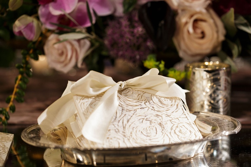 Stack of Laser-Cut Programs
Photography: Bob %26 Dawn Davis Photography
Read More:
http://www.insideweddings.com/weddings/inspiring-styled-shoot-with-deep-dark-color-palette-in-chicago/1037/ stack of laser-cut wedding programs with rose pattern tied in a bow