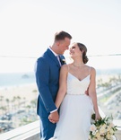 Emily Guthorn %26 Dakota Geddes-Buehre
Photography: Palos Studio
Read More:
http://www.insideweddings.com/weddings/ocean-view-ceremony-classic-reception-with-soft-blue-color-scheme/1371/ bride in v neck spaghetti strap wedding dress groom in blue suit on balcony overlooking beach ocean