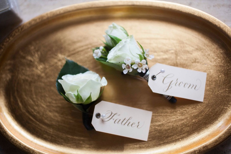 White Rose Boutonnieres with Tags
Photography: Nancy Cohn Photography
Read More:
http://www.insideweddings.com/weddings/destination-wedding-with-white-gold-color-palette-in-palm-beach/1028/ White rose flower boutonniere wedding for groom and father of groom tag white