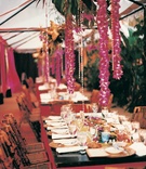Tropical Themed Flower Reception
Photography: Cari Pike Photography
Read More:
http://www.insideweddings.com/weddings/tropical-beach-wedding-in-santa-monica-california/28/ Bamboo chairs and floral garlands decorate a rustic reception