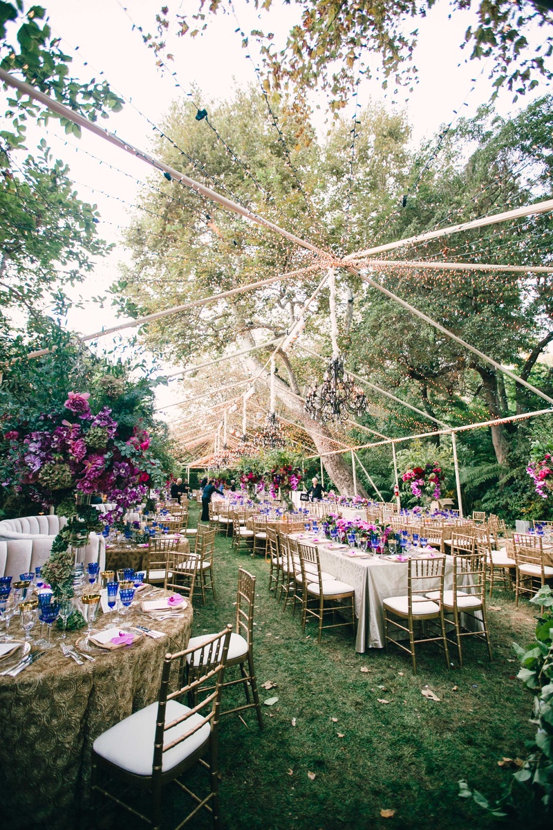 Gorgeous Outdoor Tent with String Lights
Photography: Mi Belle Photographers
Read More:
http://www.insideweddings.com/weddings/colorful-outdoor-wedding-with-supper-club-theme-in-los-angeles-ca/741/ Beautiful clear top tent at wedding reception with chandelier, string light, and purple flowers