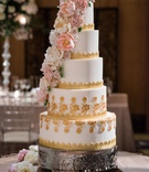 Gole + White Cake with Sugar Flowers
Photography: Kent Drake Photography
Read More:
http://www.insideweddings.com/weddings/greek-orthodox-ceremony-romantic-ballroom-reception-in-chicago/1334/ wedding cake five layers with gold details and pink white sugar flower down side of cake