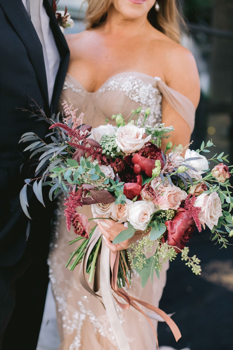 Bride with Fall Garden-Style Bouquet
Photography: Maya Myers Photography
Read More:
http://www.insideweddings.com/weddings/candlelit-jewish-ceremony-unique-cozy-outdoor-reception-in-la/1346/ bride in blush off shoulder inbal dror wedding dress foliage fall bouquet burgundy flowers