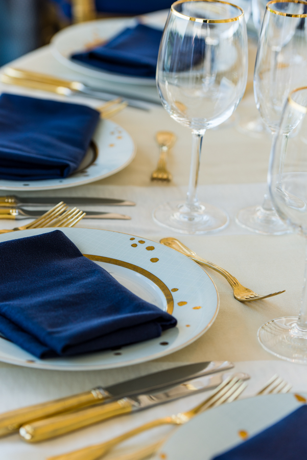 blue white and gold wedding reception table place setting