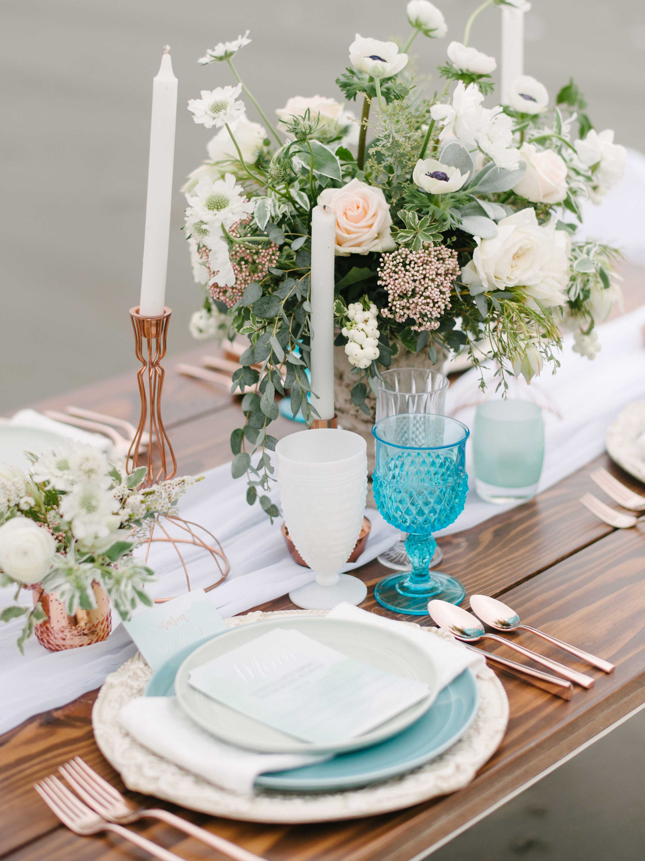 light blue napkin and goblet at wedding reception wood table