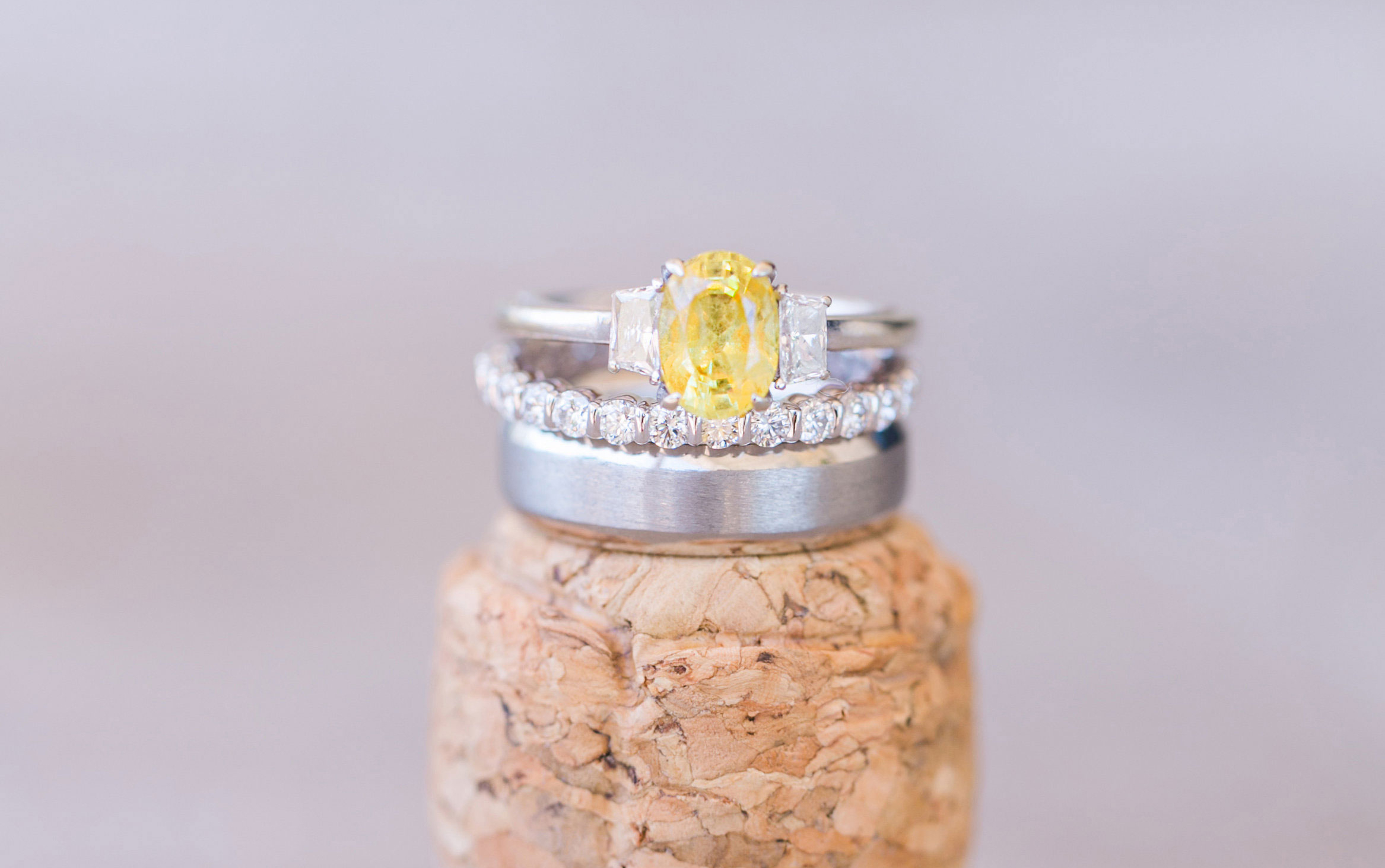 oval yellow diamond engagement ring with diamond side stones, white gold band